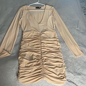 Nude V-cut dress with ruched bottom